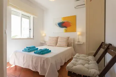 a bedroom with a bed with two towels on it at FLH Vilamoura Central Flat in Quarteira