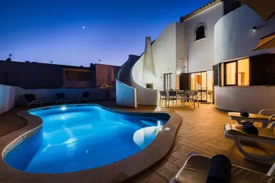 a large swimming pool in front of a house at Villa Maldives by Algarve Vacation in Montes Borralhos