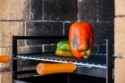 two peppers and a hot dog on a rack at Villa Maldives by Algarve Vacation in Montes Borralhos