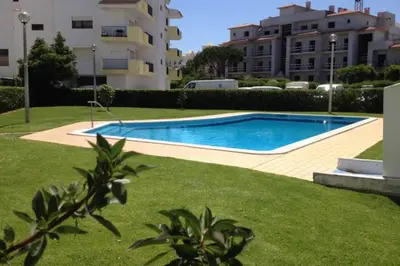 a swimming pool in a yard next to a building at Fully Renovated Studio in Albufeira