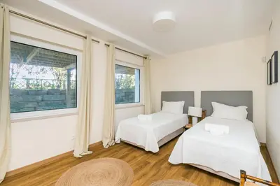 a bedroom with two beds and a window at Villa Formosa Golf in Quinta do Lago
