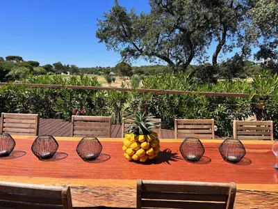 a wooden table with a bowl of fruit on it at Villa Formosa Golf in Quinta do Lago