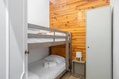 a bedroom with two bunk beds and a mirror at The Central Townhouse in Faro