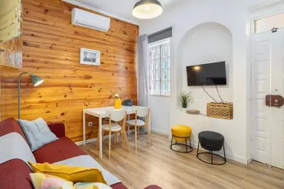 a room with a bed and a table with chairs at The Central Townhouse in Faro