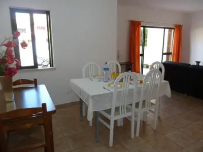 a dining room with a white table and chairs at Holiday House in Albufeira