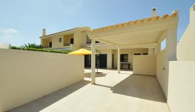 a patio of a house with a white fence at Holiday House in Albufeira