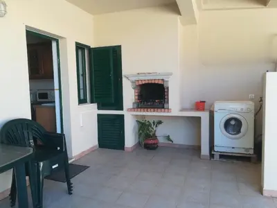 a laundry room with a washer and dryer in a house at Holiday House in Albufeira