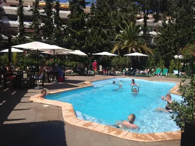 a group of people swimming in a swimming pool at Casa Balaia in Albufeira