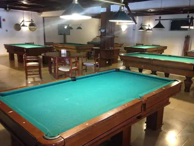 a pool table in a room with many tables at Casa Balaia in Albufeira