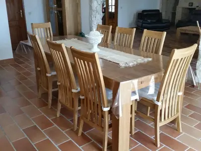 a wooden dining room table with chairs and a table and a table and chairsktop at Villa Quinta da Violeta in Loulé
