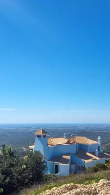 a white house on top of a hill at Villa Quinta da Violeta in Loulé