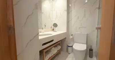 a white bedroom with a white dresser and a mirror at Quinta do Lago Beach House in Quinta do Lago