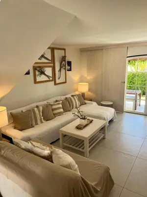 a living room with two beds and a couch at T4 Grand Townhouse Old Village in Vilamoura