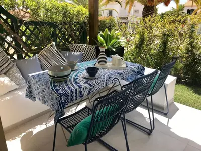 a table with a blue and white table cloth on a patio at T4 Grand Townhouse Old Village in Vilamoura