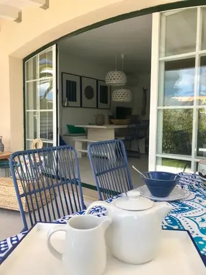 a table with blue and white dishes on it at T4 Grand Townhouse Old Village in Vilamoura