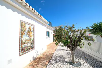 a wall with a painting on the side of a building at Villa Tibouchina in Albufeira
