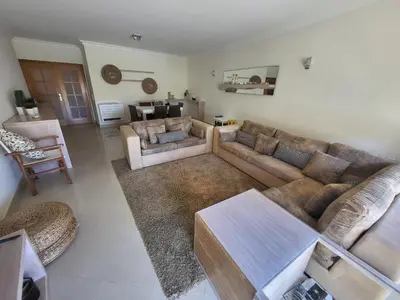a living room with a couch and a table at Apartamento Vilamoura in Quarteira