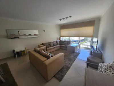 a living room with two couches and a television at Apartamento Vilamoura in Quarteira
