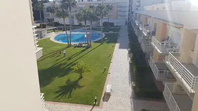 a view from a balcony of a building with a swimming pool at Apartamento Vilamoura in Quarteira