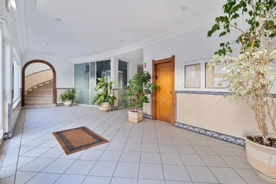 an empty hallway with potted plants in a building at Penthouse Sea View by Albufeira Holidays in Albufeira