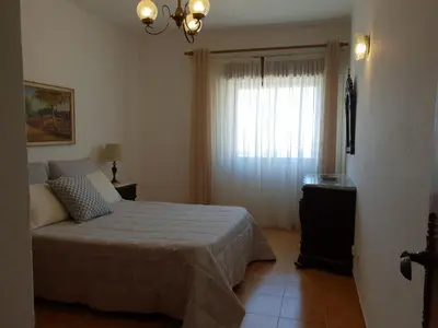 a bedroom with a large bed and a window at Apartment on The Strip Albufeira in Albufeira