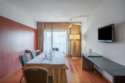 a living room with a large painting on the wall at Crowne Plaza Vilamoura - Algarve by IHG in Vilamoura