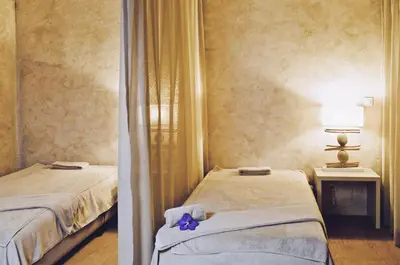a bedroom with two beds and a purple flower on the bed at Crowne Plaza Vilamoura - Algarve by IHG in Vilamoura