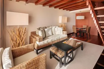 a living room with a staircase and a couch at Crowne Plaza Vilamoura - Algarve by IHG in Vilamoura