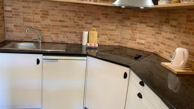 a kitchen with white cabinets and a sink at Apartamento Bela Vista in Albufeira