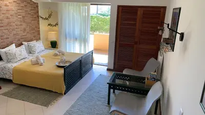 a bedroom with a bed and a table and chairs at Apartamento Bela Vista in Albufeira