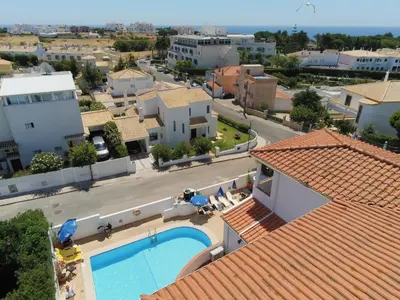 an aerial view of a house with a swimming pool at Agua Marinha ROSA- Hotel in Albufeira