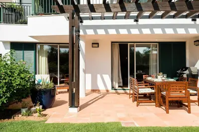 a patio with a table and chairs on a patio at Birdsong Vila Sol Village in Vilamoura