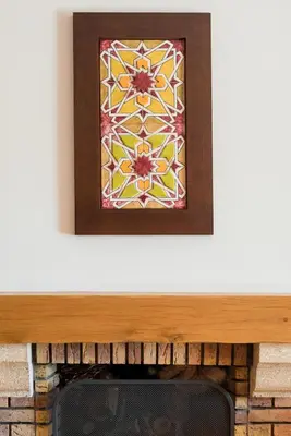 a stained glass window on top of a fireplace at Birdsong Vila Sol Village in Vilamoura