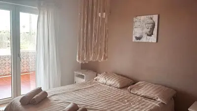 a bedroom with a bed with pillows and a window at Cegonha Villa powered by Cegonha Resort- Private swimming pool & air con in Albufeira