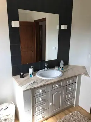 a bathroom with a sink and a large mirror at Cegonha Villa powered by Cegonha Resort- Private swimming pool & air con in Albufeira