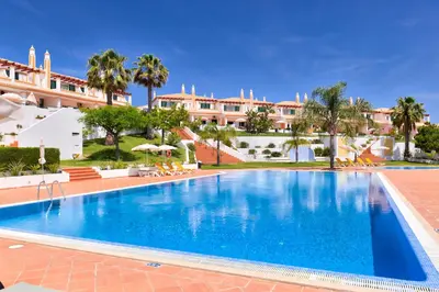 a large swimming pool in front of a building at Moradias Villas Rufino in Albufeira