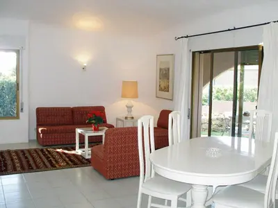 a living room with a white table and a couch at Lageado Park in Albufeira