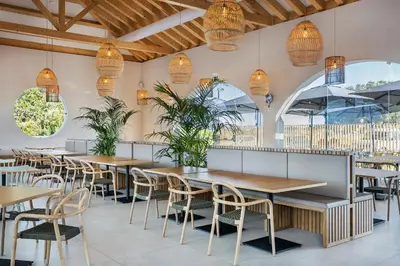 a restaurant with tables and chairs and potted plants at Eden Villas & Apartments in Albufeira