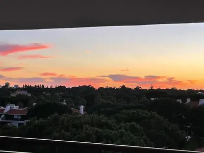 a sunset over a city with trees and buildings at Boa Vida in Quarteira