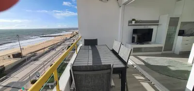 a balcony with a table and a view of the beach at ACR Holiday Apartment in Quarteira