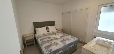 a small bedroom with a bed and a window at ACR Holiday Apartment in Quarteira