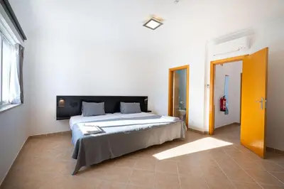 a bedroom with a large bed in a room at Smy Santa Eulalia Algarve in Albufeira