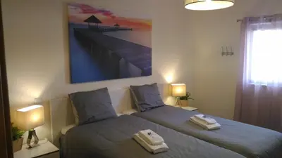 a bedroom with two beds with towels on them at Apartamento O Jardins da Marina in Albufeira
