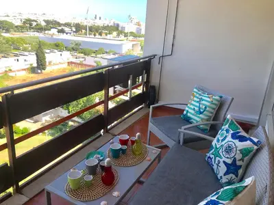 a balcony with two tables and chairs with cups on them at Romantic Studio By Ethnic Ocean in Vilamoura