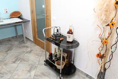 a wine cart with bottles on it in a room at Vivenda Luz - Jacuzzi & Swimming Pool in Albufeira
