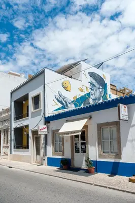 a building with a painting on the side of it at Lemon Tree Stay in Faro