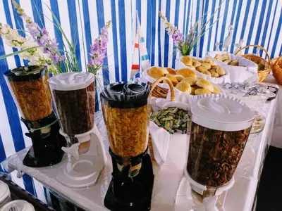 a table with three cups filled with food and bread at Hotel da Gale in Albufeira