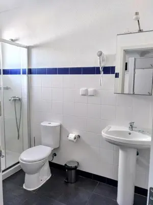 a bathroom with a toilet and a sink and a shower at Hotel da Gale in Albufeira