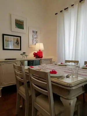 a dining room table with chairs and a table with at Casa da Guida in Albufeira