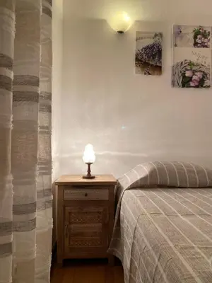 a bedroom with a bed and a lamp on a night stand at Casa da Guida in Albufeira